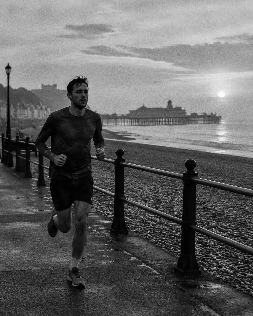 Runner on a seafront promenade at dawn